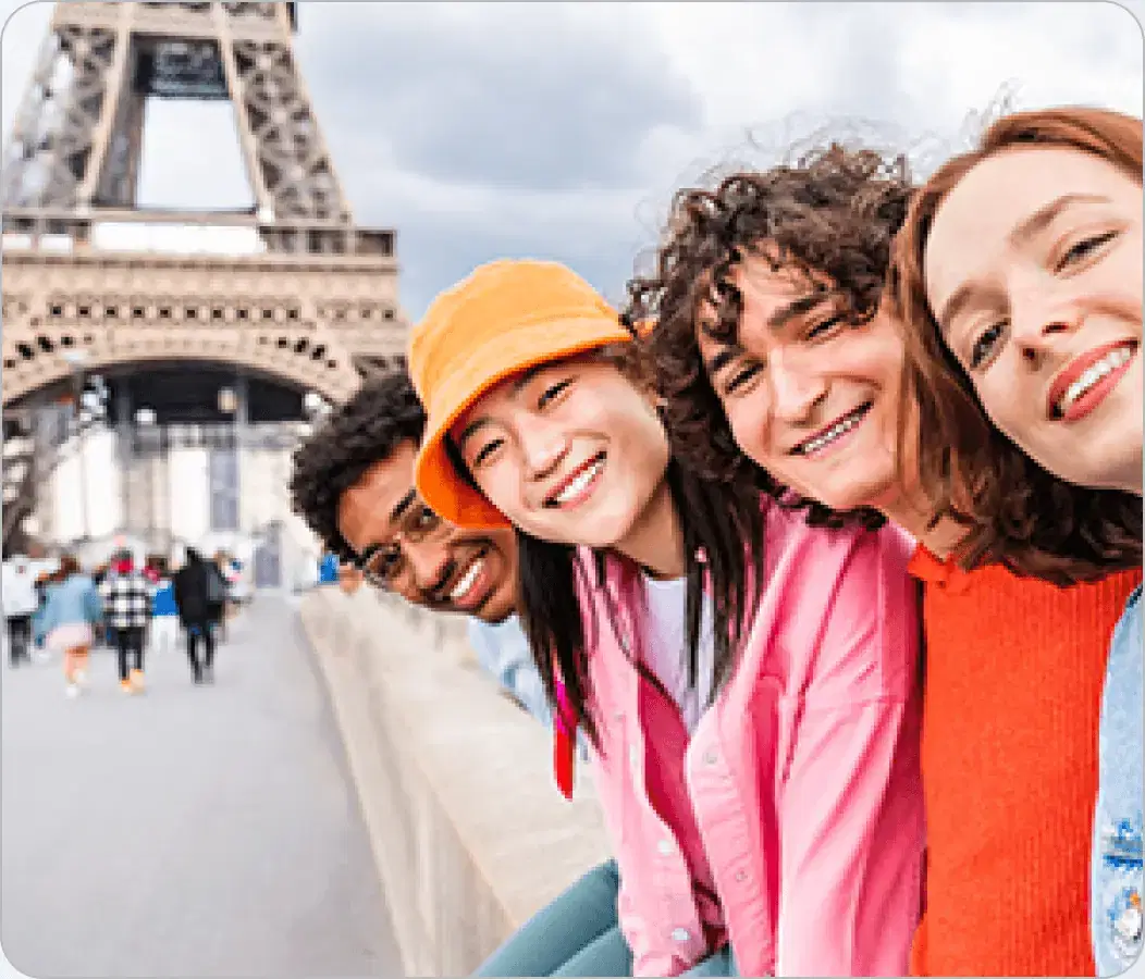 Four friends taking a selfie in front of the Eiffel Tower